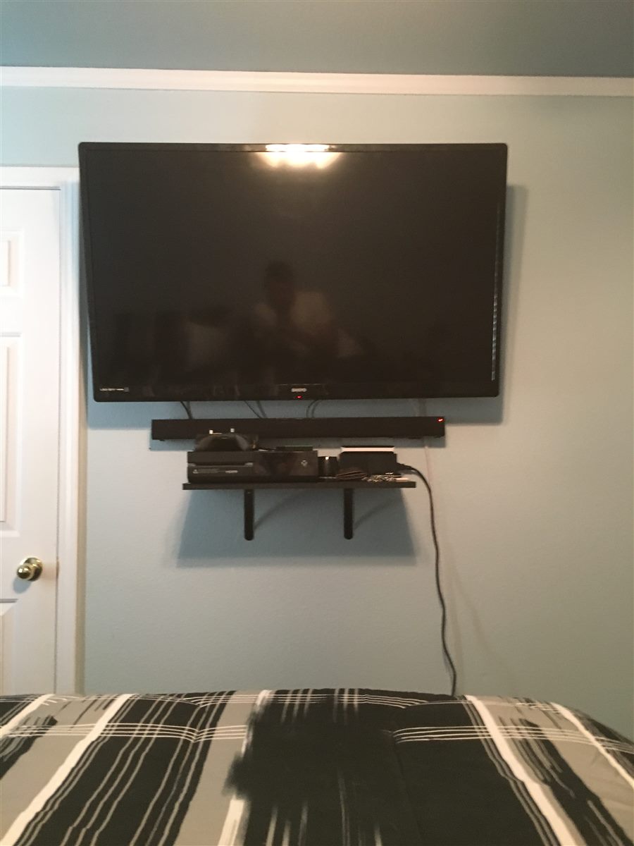 Mounted TV with soundbar and media shelf for a Treasure Valley homeowner